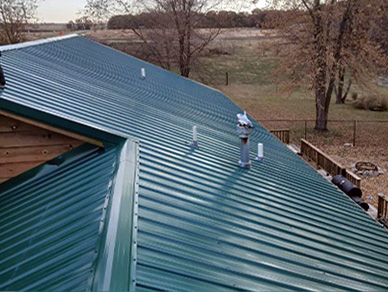 Green metal roof with chimney