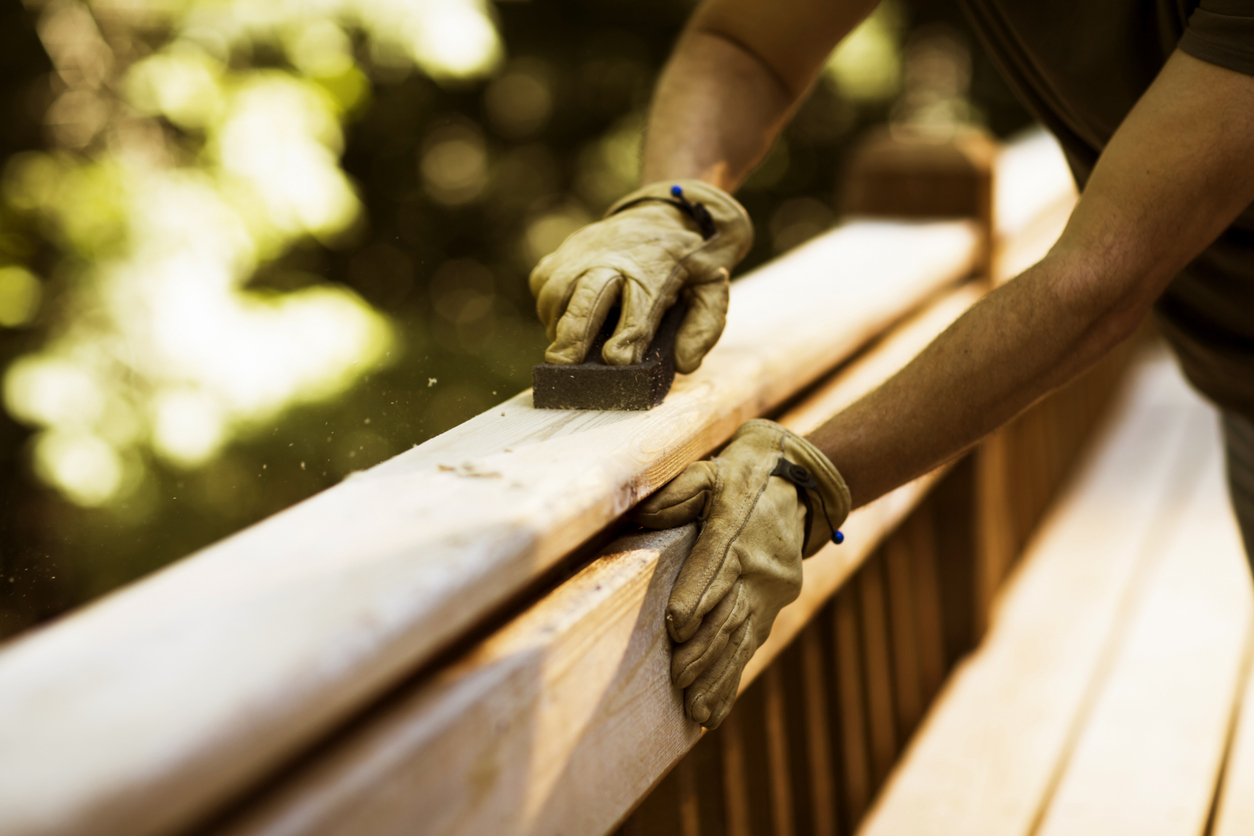 Carpenter sanding cedar wood decks in Jacksonville IL